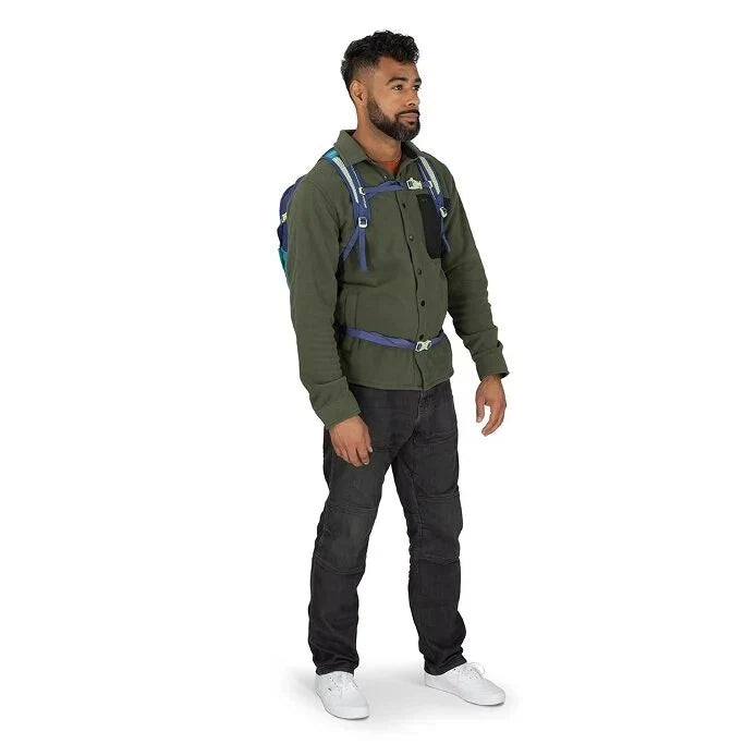 Man wearing a green jacket and black pants with a backpack on a white background