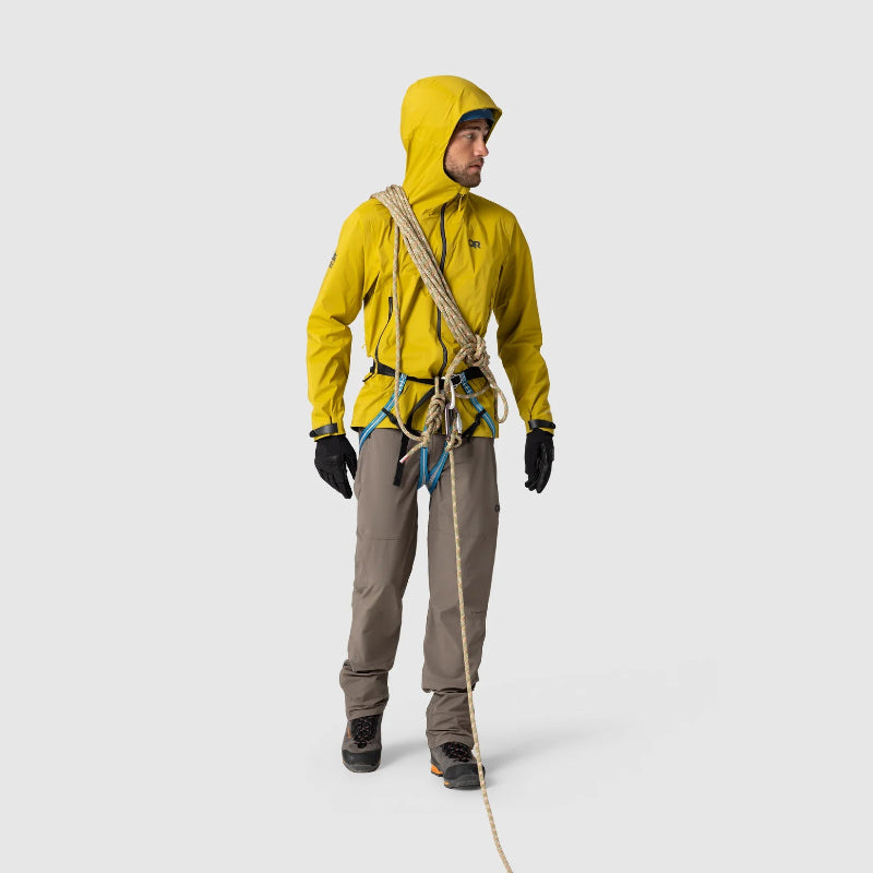 Person wearing a yellow raincoat with climbing equipment on a white background