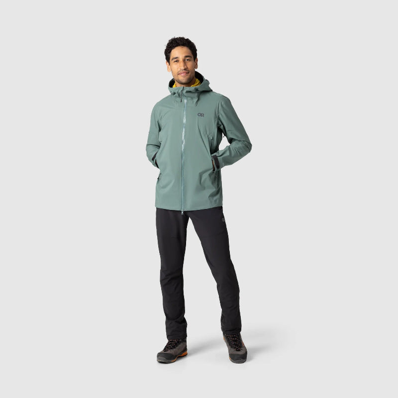 Person wearing a green raincoat on a light gray background