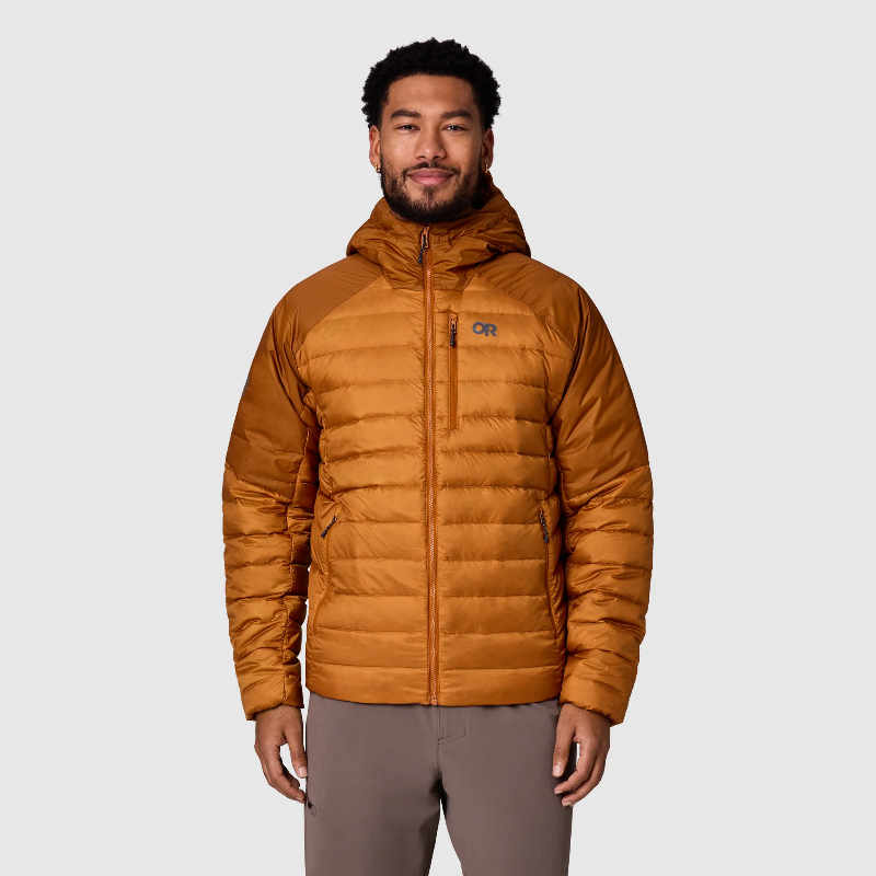 Man wearing a brown puffer jacket on a light gray background