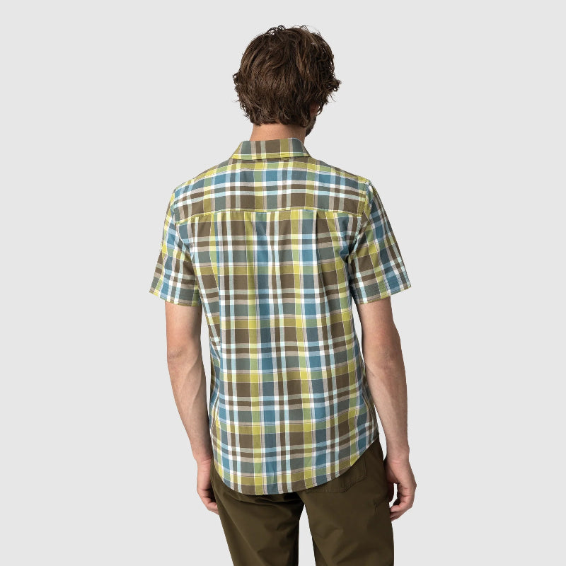 Person wearing a plaid shirt on a plain background