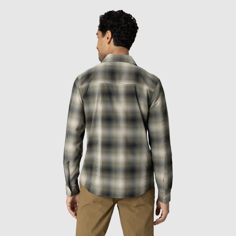 Person wearing a plaid shirt and beige pants on a light gray background