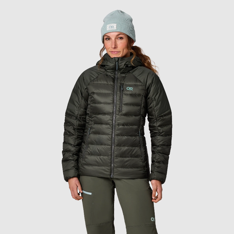 Person wearing a dark green Outdoor Research puffer jacket with a brand logo on a light gray background