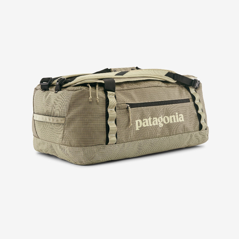 Beige duffel bag with Patagonia logo on a white background