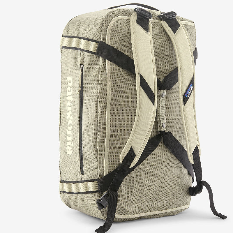 Beige backpack with black straps on a white background