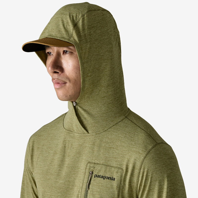 Man wearing the Patagonia Men’s Capilene Cool Sun Hoody Fitz Roy Trout with a cap under the hood