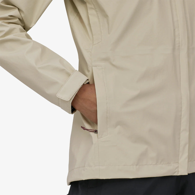 Woman wearing the Patagonia Women's Torrentshell 3L Rain Jacket with her hand in the pocket