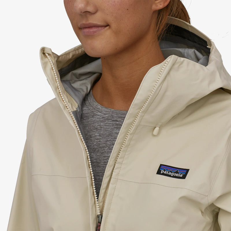 The Patagonia Women's Torrentshell 3L Rain Jacket worn by a woman with the front zip undone