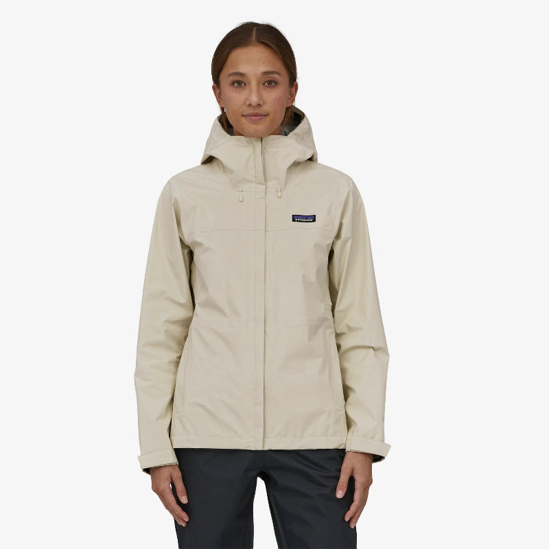 Woman wearing the Patagonia Women's Torrentshell 3L Rain Jacket in wool white