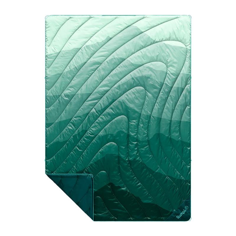 A quilted sleeping pad with a wavy, organic pattern in a gradient of mint green to deep teal, shown on a plain white background with one corner folded over.