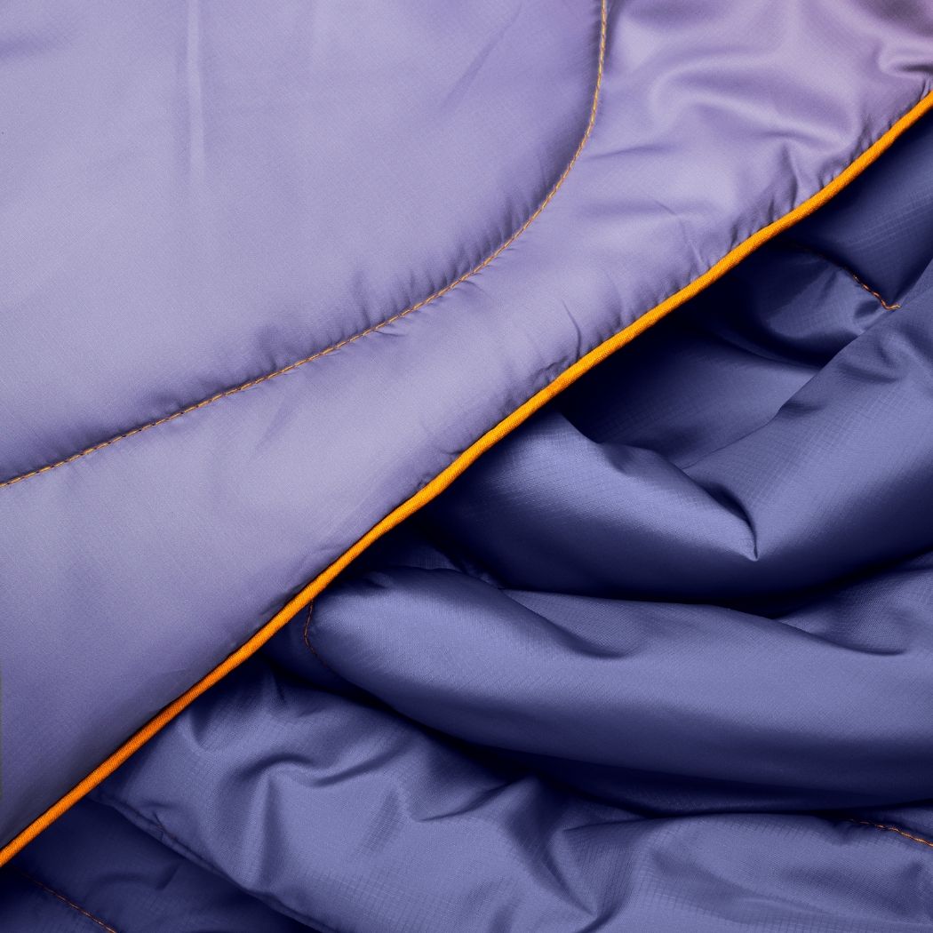 Close-up of purple quilted fabric with yellow stitching