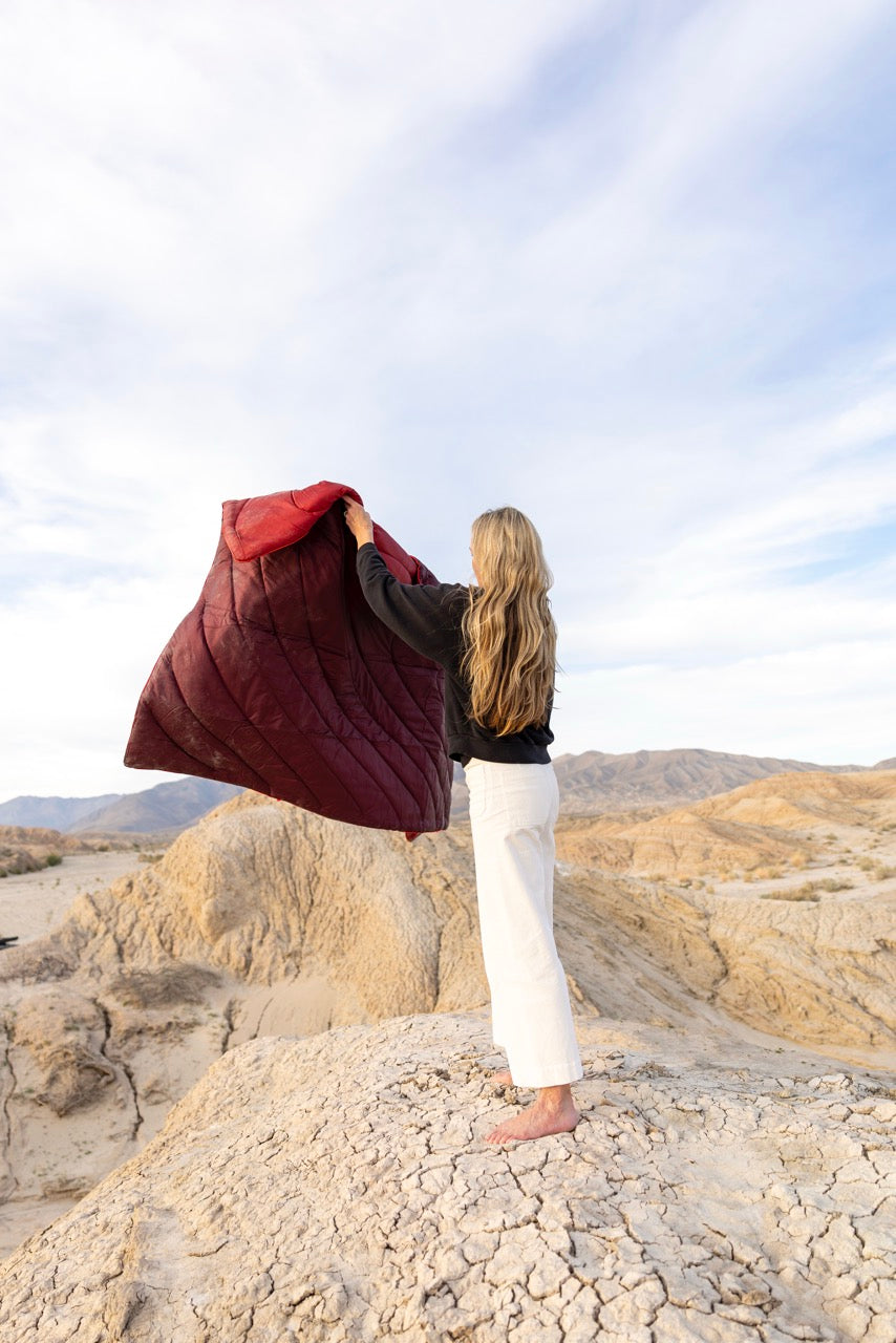 Woman holding a rumpl waterproof blanket australia