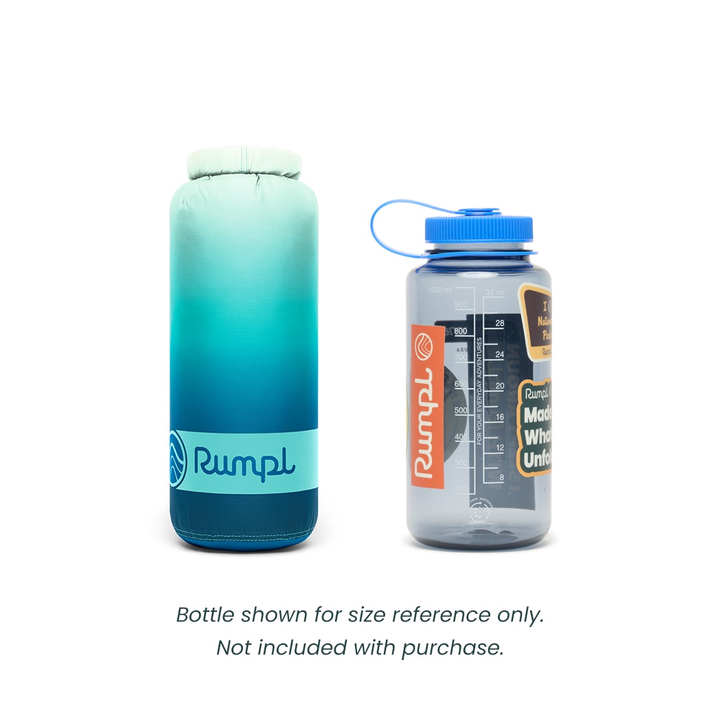 Blue Rumpl waterproof blanket next to a nalgene bottle 