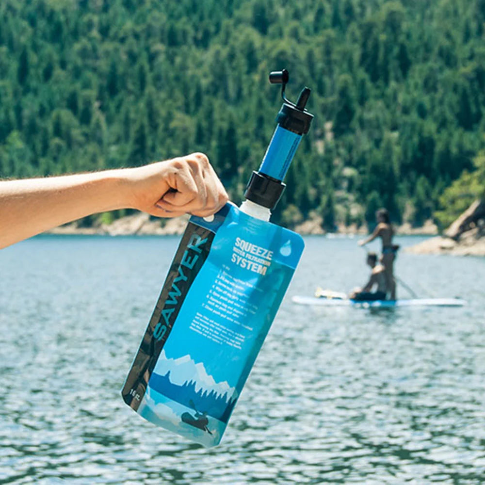 Sawyer Mini Water Filter Blue in use on a lake
