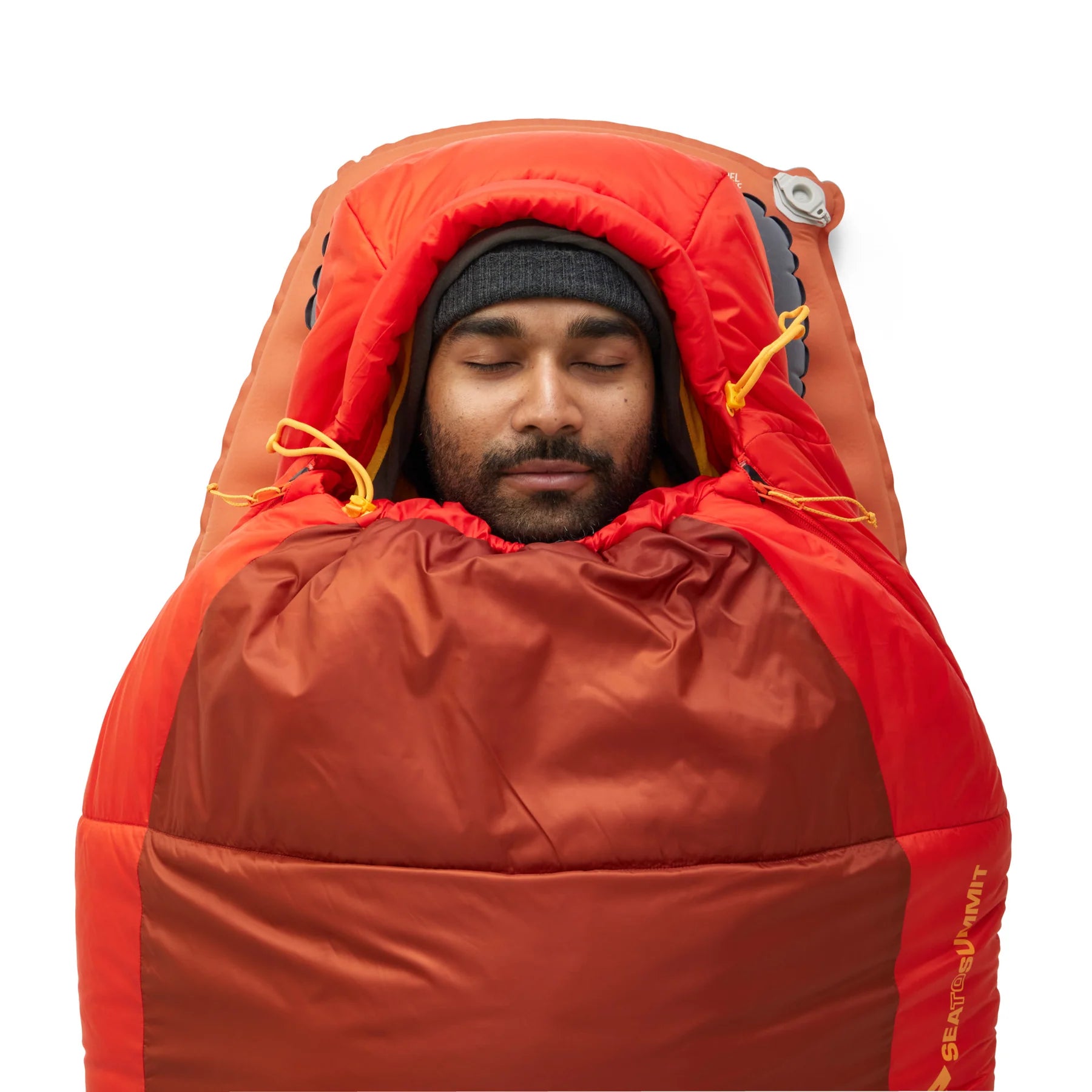 Person sleeping in a red sleeping bag with a white background