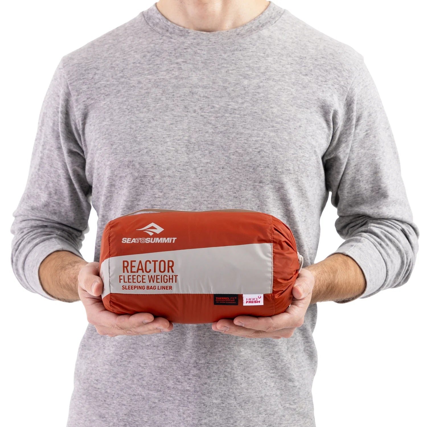 Person holding a Sea to Summit Reactor Fleece Weight sleeping bag liner.