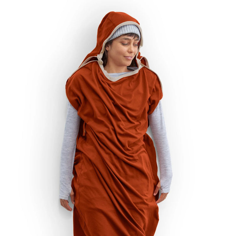 Person wearing a rust-colored liner over a light gray long-sleeve shirt on a white background