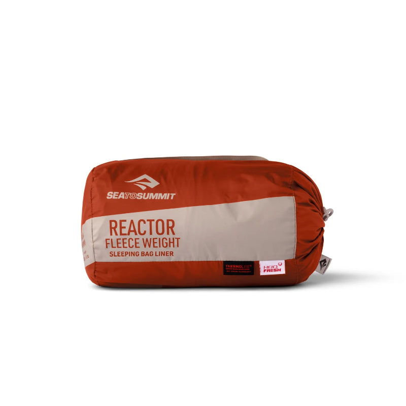 Red sleeping bag liner with 'Sea to Summit' branding on a white background