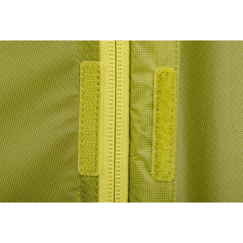 Close-up of a green textured fabric with a zipper and velcro closures.