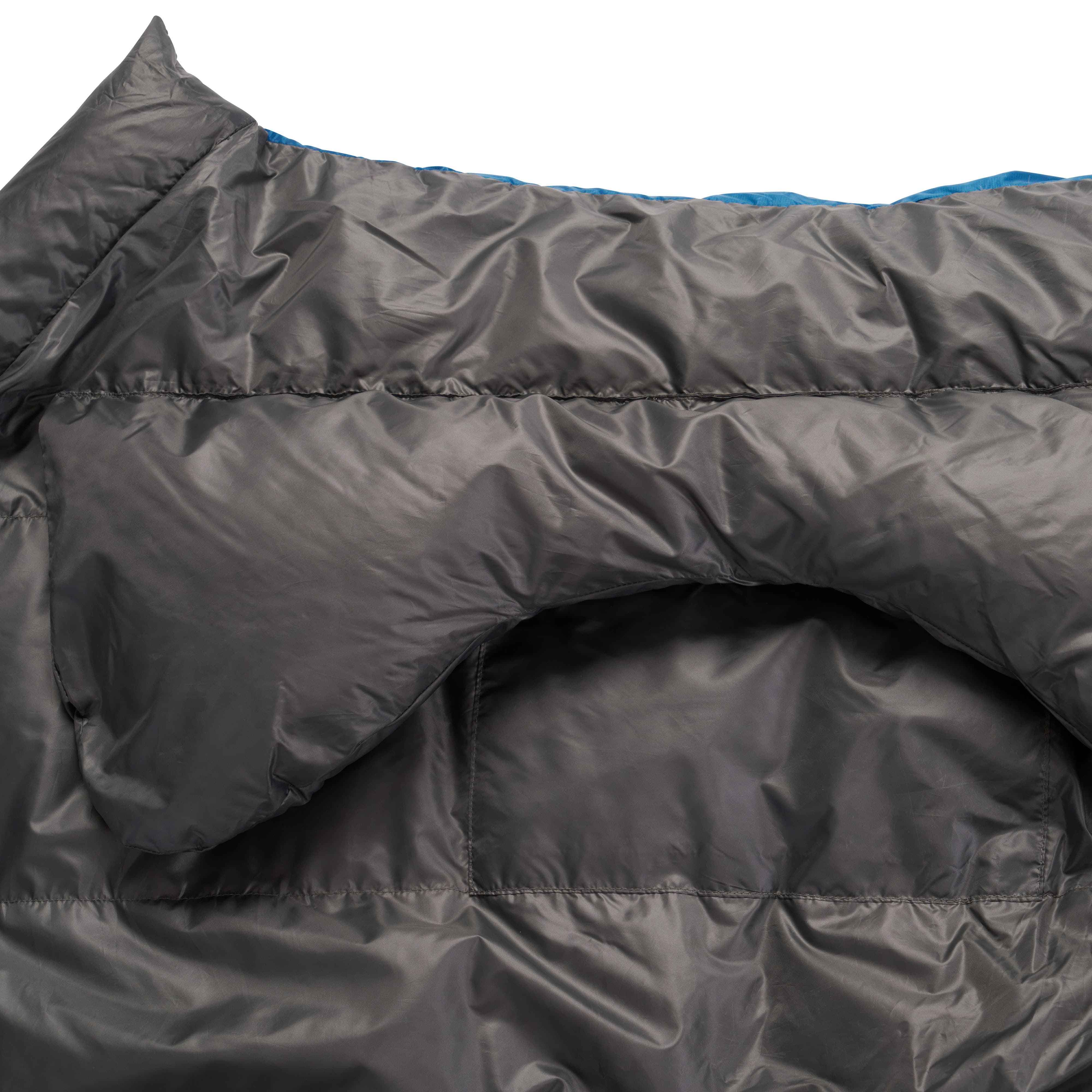 Close-up of the inside of dark gray exped lightweight sleeping bag for hiking on white background