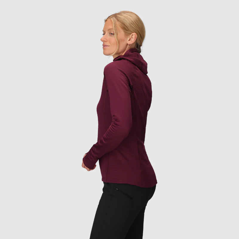 Woman wearing a burgundy jacket on a light gray background