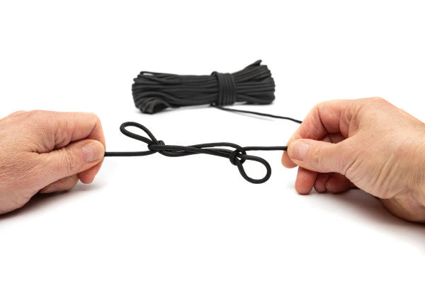 Two hands holding a black rope on a white background